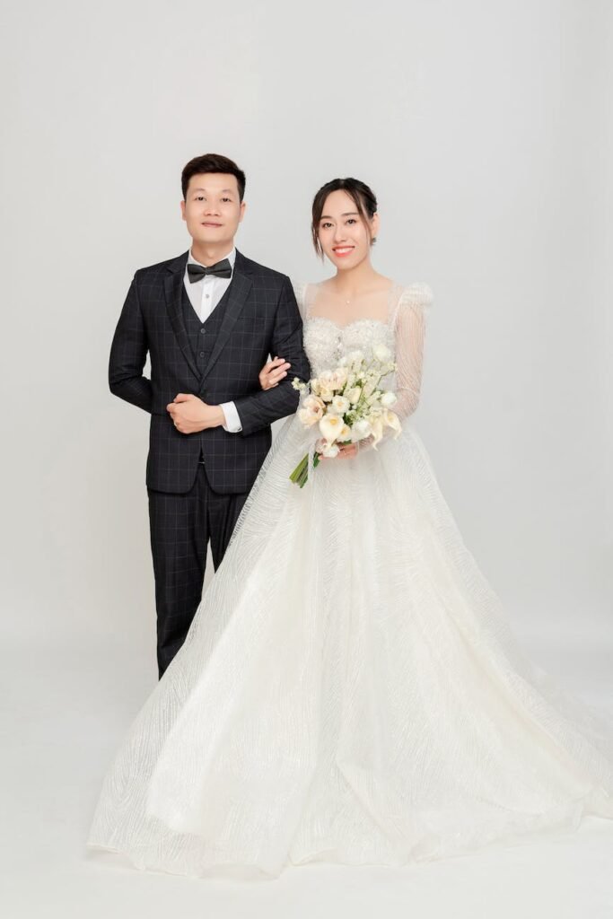 a man in a black suit and a woman in a white gown