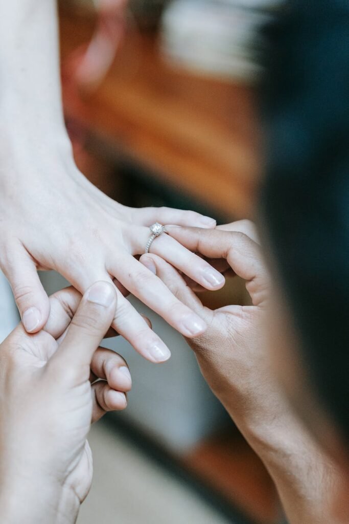 a person putting on an engagement ring