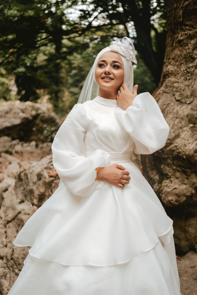 woman in white long sleeve dress wearing white hijab