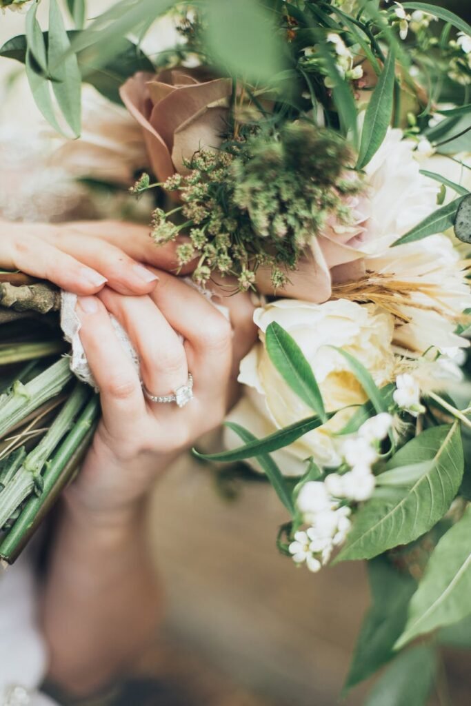 person holding white flowers